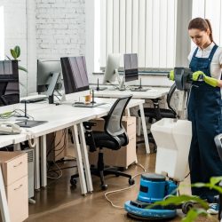 young-cleaner-washing-floor-in-open-space-office